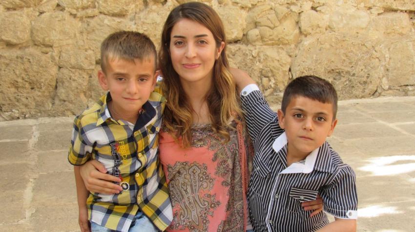 Adiba Qasim visits Lalish, a Yazidi holy site in northern Iraq, in 2016 with Hani and Evan, whose fathers were killed by ISIS fighters.